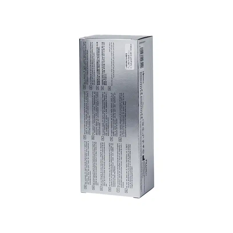 The image shows a silver metallic box standing upright. The box has text in multiple languages and various sized font on one side. There is a barcode and some other printed information towards the top of the box. The background is plain white. The box is FILLMED® ART FILLER FINE LINES with Lidocaine.