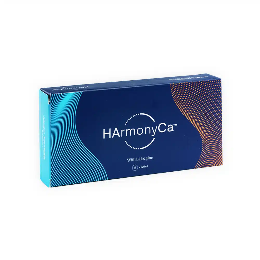 A rectangular box with a blue and teal design featuring curved lines and dots. The box reads "HArmonyCA™ with Lidocaine." The branding is prominently displayed in the center of the box against a dark blue background.