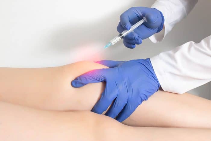 A healthcare professional wearing blue gloves administers Euflexxa injections into the knee of a patient lying down. The injection area is highlighted with a red glow, indicating the focus of treatment.