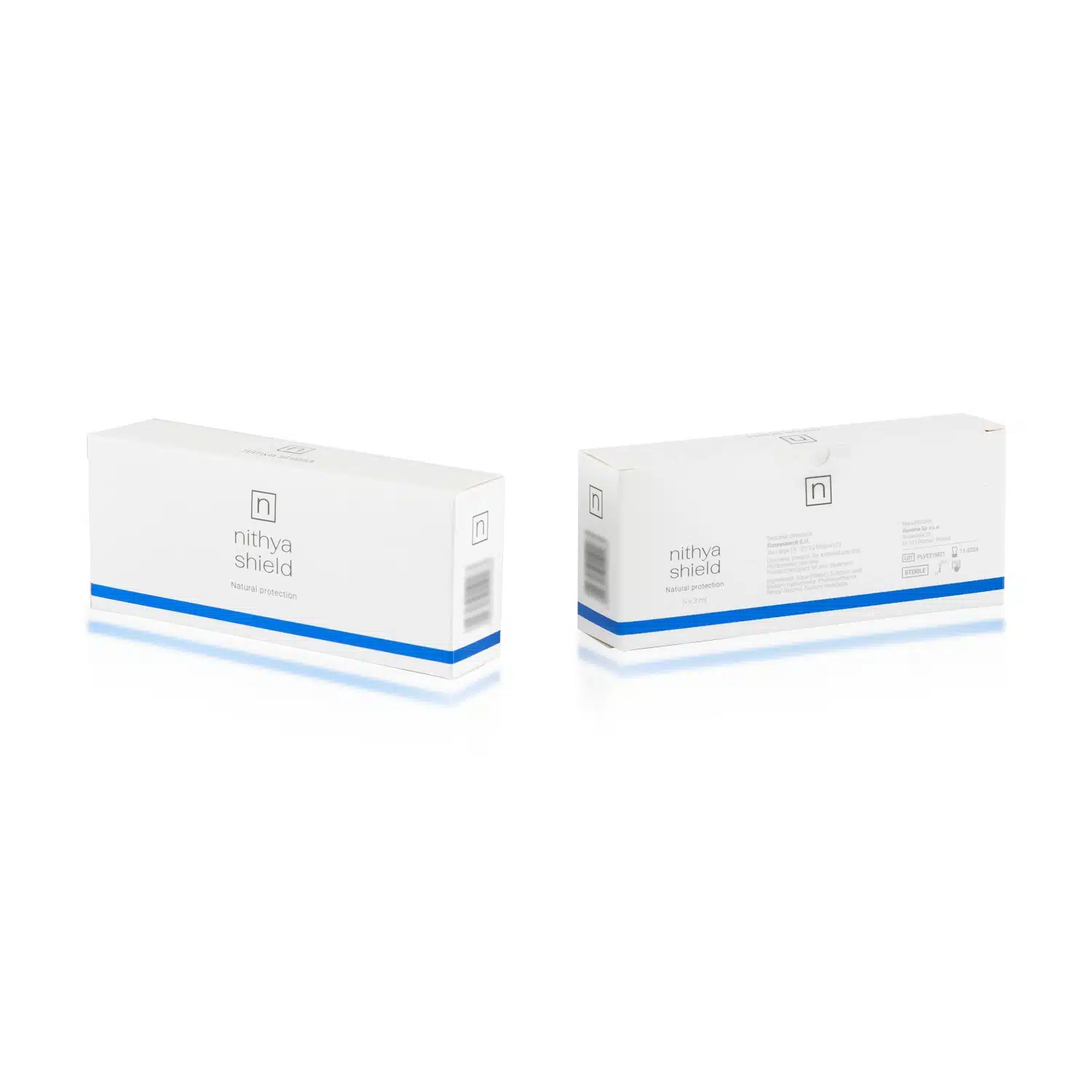Two white rectangular boxes of "NITHYA SHIELD" are shown. The front of one box, on the left, displays the product name and logo, while the back of the other box, on the right, includes detailed text, likely instructions or ingredients. Both boxes feature a blue stripe along the bottom.
