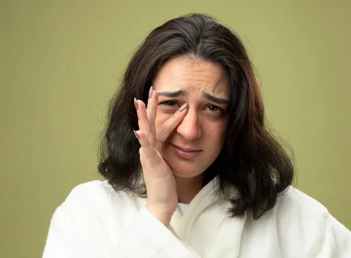 Woman touching her face.